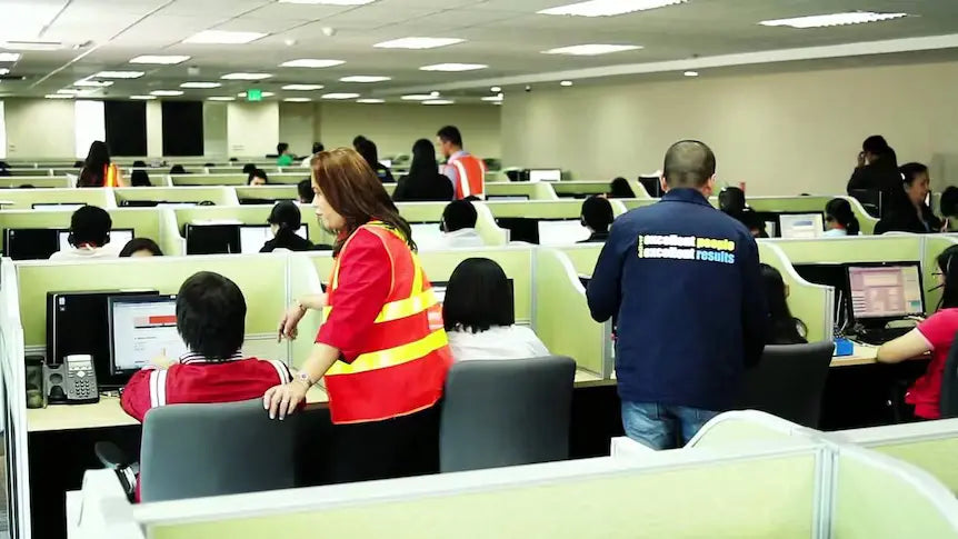 People working at computer stations in overseas call centre